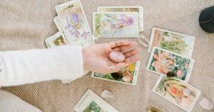 palm with crystal and tarot cards on table as a new psychic