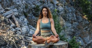 female psychic empath meditating on rock